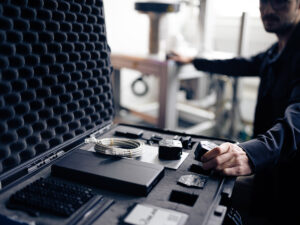 Technician installing components for data collection on production machine